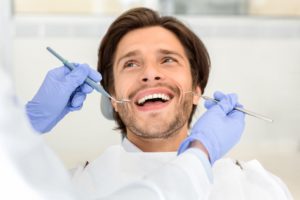 portrait-of-handsome-smiling-man-attending-dentist-BBR8FWX (1)