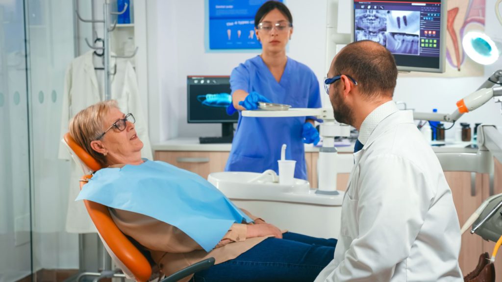 old woman having medical treatment at dentist offi 2021 08 29 18 16 48 utc